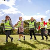 Chris Carlin, Marketing Manager Miller Homes Yorkshire, gives high-vis vests to children from year R to year 6 at Harworth Primary School