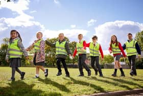 Chris Carlin, Marketing Manager Miller Homes Yorkshire, gives high-vis vests to children from year R to year 6 at Harworth Primary School