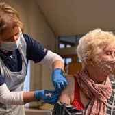 A member of the public receives the Oxford/AstraZeneca Covid-19 vaccine at a temporary vaccination centre in St Columba's Church in Sheffield (Photo by OLI SCARFF/AFP via Getty Images)