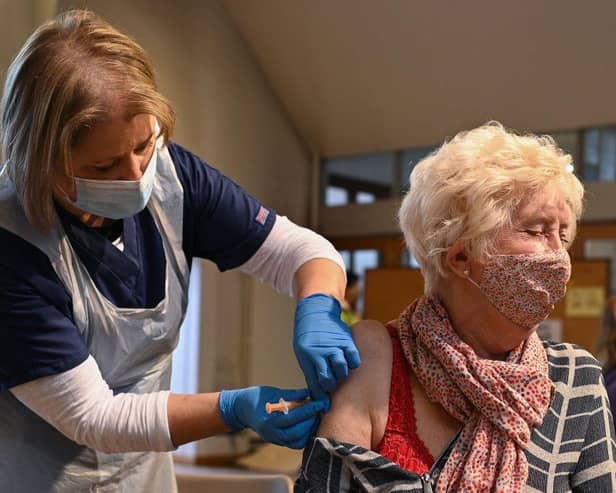 A member of the public receives the Oxford/AstraZeneca Covid-19 vaccine at a temporary vaccination centre in St Columba's Church in Sheffield (Photo by OLI SCARFF/AFP via Getty Images)