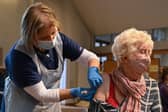 A member of the public receives the Oxford/AstraZeneca Covid-19 vaccine at a temporary vaccination centre in St Columba's Church in Sheffield (Photo by OLI SCARFF/AFP via Getty Images)