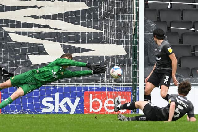 Louis Jones makes an excellent save from MK Dons' Will Grigg. Picture: Howard Roe/AHPIX