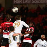 Joe Ironside goes up for a header for Doncaster Rovers against Salford City.
