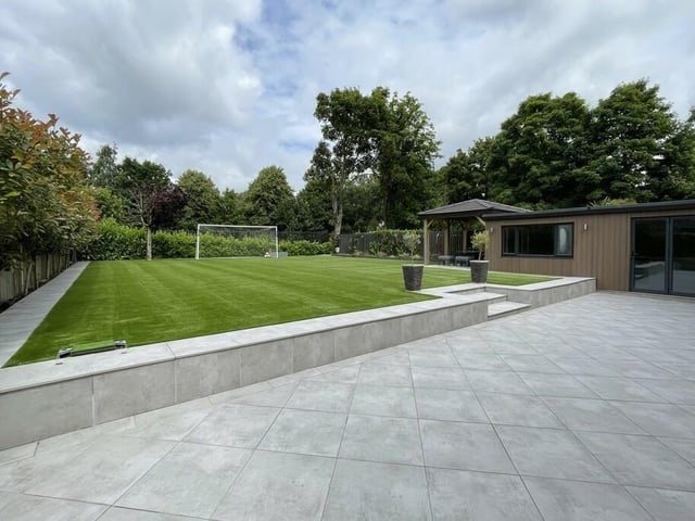 The private rear garden, with a large patio seating area.