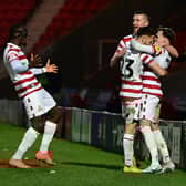 Doncaster's players celebrate Kyle Hurst's goal.