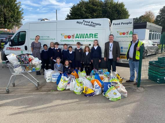 Students from Conisbrough Ivanhoe Primary Academy alongside Sean Gibbons (second from right) and Mark Dockerty, Mexborough Foodbank Coordinator (far right).