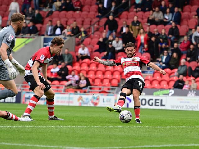 Jon Taylor goes close with a shot against Harrogate on the opening day.