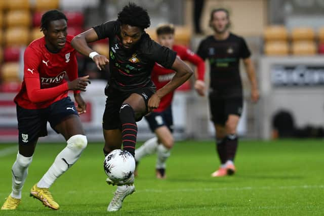 Deji Sontona gets away from a York City defender.