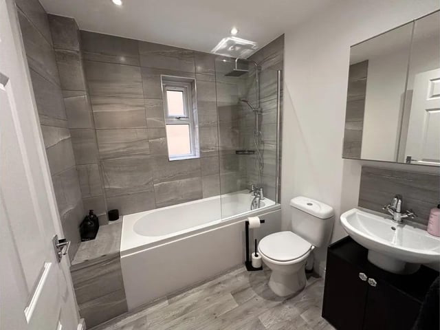 The stylish house bathroom, with both bath and shower.