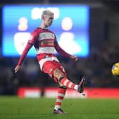 Doncaster Rovers midfielder Zain Westbrooke puts the ball into the box against AFC Wimbledon.