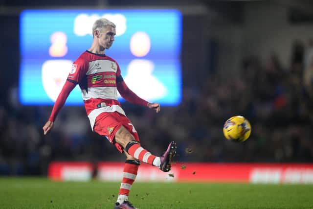 Doncaster Rovers midfielder Zain Westbrooke puts the ball into the box against AFC Wimbledon.