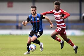Jason Lokilo harries Jimmy Keohane of Rochdale