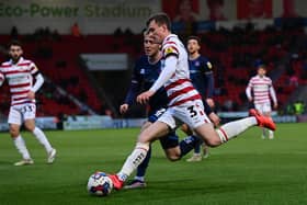 Doncaster's James Maxwell puts the ball into the six-yard box against Carlisle United.