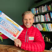 Lottery ambassador Jeff Brazier with one of the winning cheques