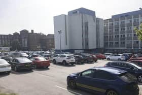 A nurse working at DRI has hit out at bosses over staff being chased for unpaid parking fines.