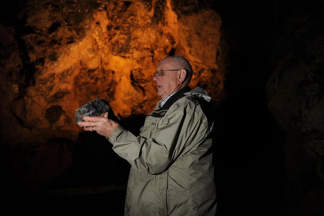 A 'lost' vein of rare Blue John stone has been discovered at Treak Cliff Cavern in the Peak District. Peter Harrison inside the cavern with a large piece of Blue John in 2013
