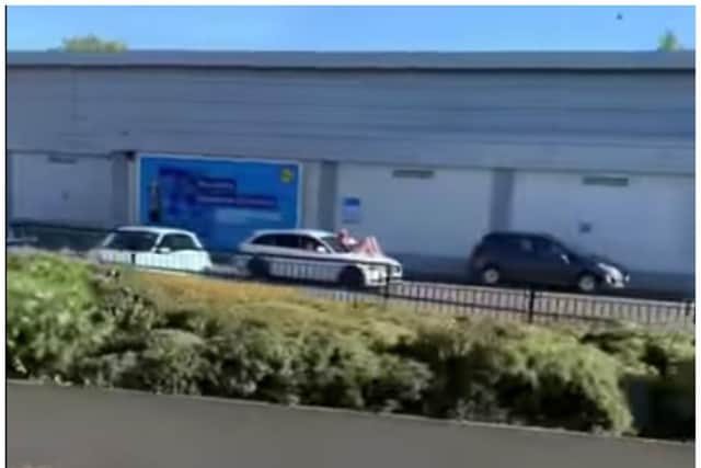 The woman was filmed sprawled across the bonnet of the car as it drove through Mexborough.