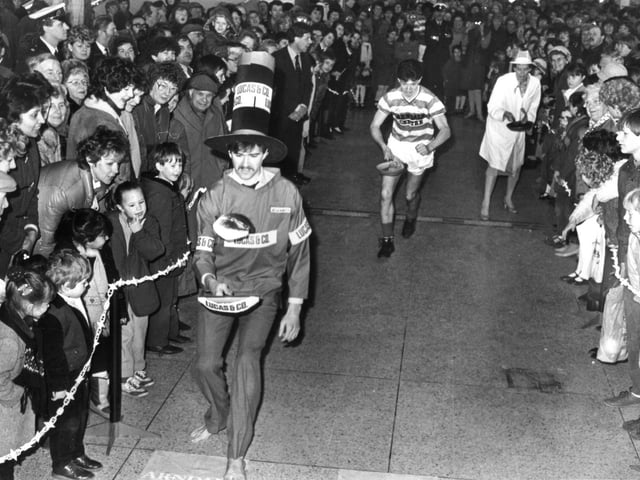 Action from the pancake race in the Arndale Centre between the Arndale Managers, Arndale staff and Doncaster Rovers, February 1985