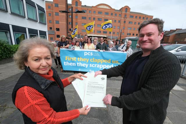 PCS members gather outside the DWP building in Wood Street, Doncaster after the government announced redundencies in the sector. Branch secretary Mathew Meehan presents a petition opposing the changes to Doncaster Central MP Dame Rosie Winterton. Credit: PCS/Mark Harvey.