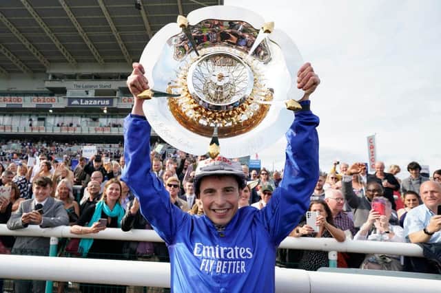 William Buick celebrates with the trophy after riding Hurricane Lane to victory in the Cazoo St Leger Stakes at Doncaster. Photo by Alan Crowhurst/Getty Images