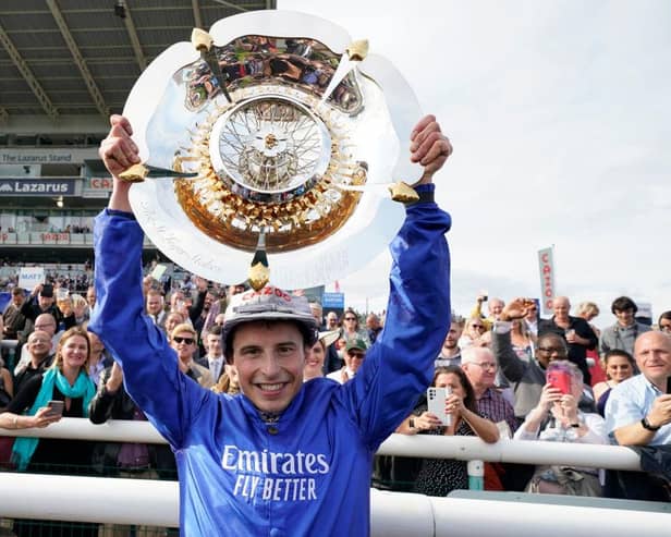 William Buick celebrates with the trophy after riding Hurricane Lane to victory in the Cazoo St Leger Stakes at Doncaster. Photo by Alan Crowhurst/Getty Images