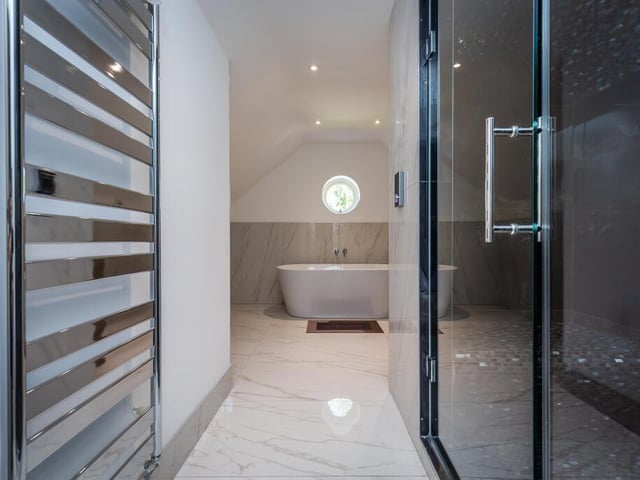 The second floor bathroom includes a walk-in shower and a steam room.