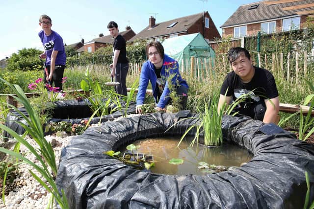 Harrison College students, Nat Bennetts-McBride, Thomas Wedgwood, Nathaniel Blair and Reece Chan working on the new pond area at Saltersgate Infant School.