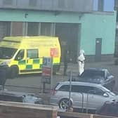 Ambulance and a person in a hazmat suit at the Flying Scotsman surgery.