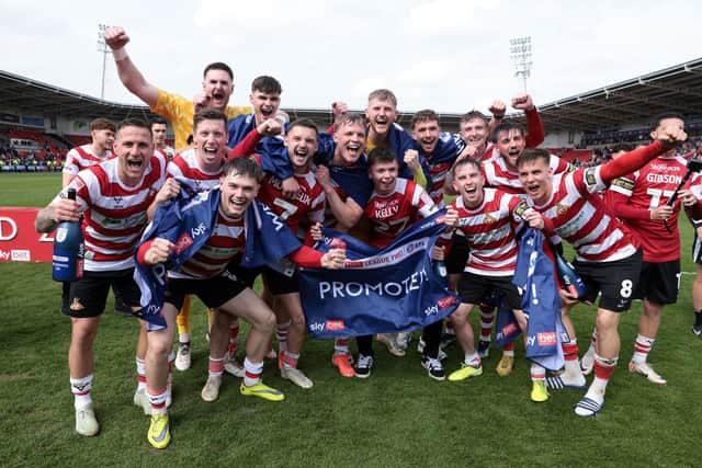 Rovers players celebrate promotion. Ian Hodgson/PA Wire.