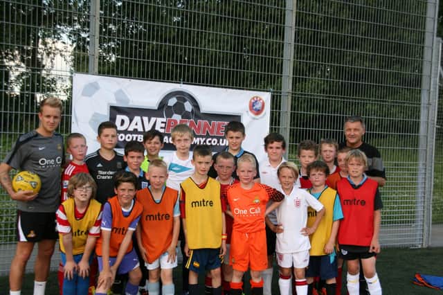 James Coppinger with Dave Penney and youngsters at the former Rovers boss' academy