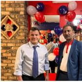 Absolute Cabs owner Jaan Saqlain (right) has put up red, white and blue balloons for the firm's ninth anniversary and the death of The Queen.