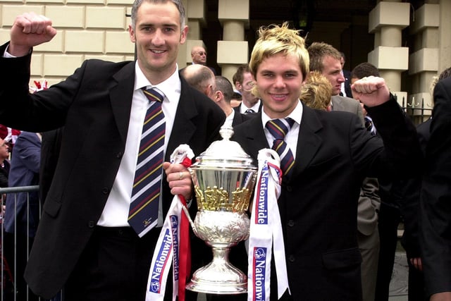 Goalkeeper Andy Warrington and Jamie Price with the Division Three Championship trophy.