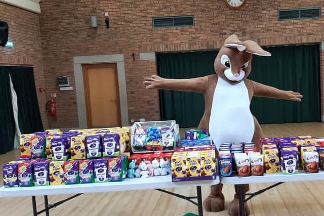 A group of volunteers is collecting Easter eggs for children.