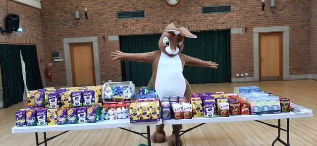 A group of volunteers is collecting Easter eggs for children.