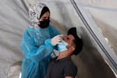 A nurse administers a Covid test.