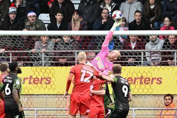Jonathan Mitchell clears under pressure.