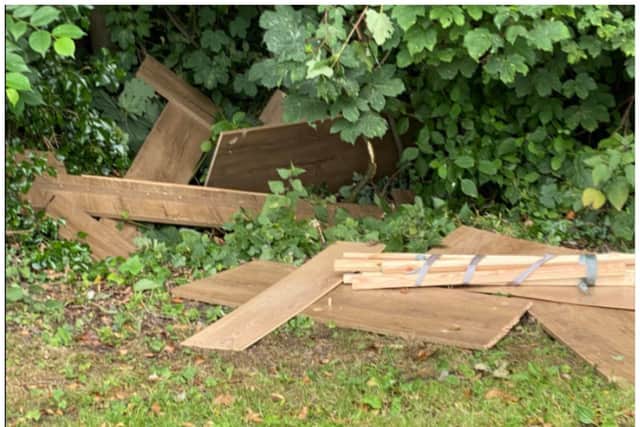 Piles of wood were dumped at the side of Holme Lane.