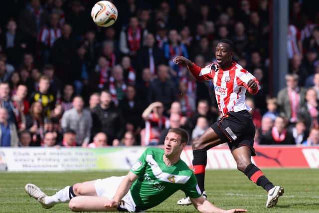 Jamie McCombe tries to block a shot from Bradley Wright-Phillips