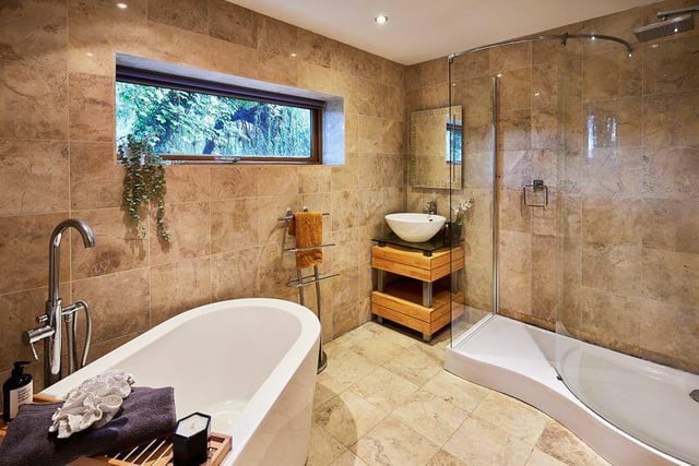 A luxury bathroom with walk-in shower and free-standing bath tub.