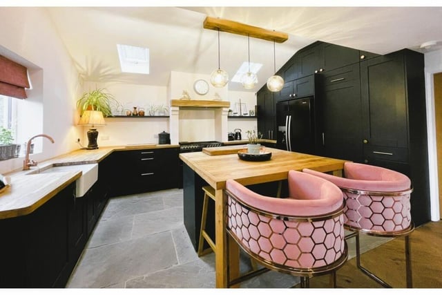 A modern kitchen, with island and breakfast bar.