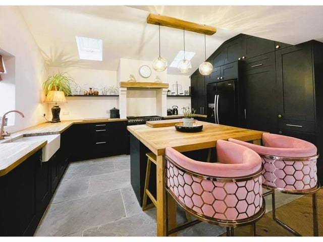 A modern kitchen, with island and breakfast bar.