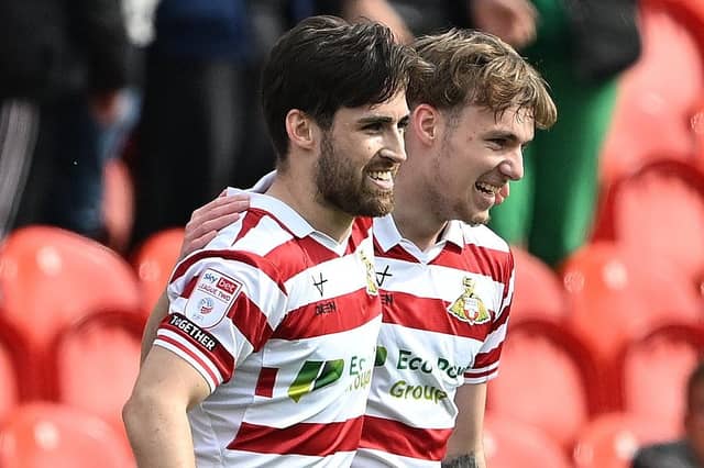 Doncaster's Aidan Barlow celebrates with Doncaster's goalscorer Kyle Hurst.