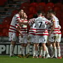 Doncaster's players celebrate Ben Close's goal against Tranmere.