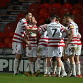 Doncaster's players celebrate Ben Close's goal against Tranmere.