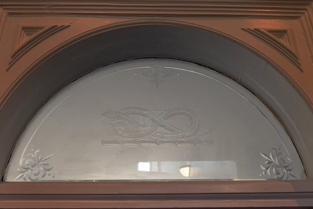 A restored piece of frosted glass with Serpentine insignia - the oldest part of the building