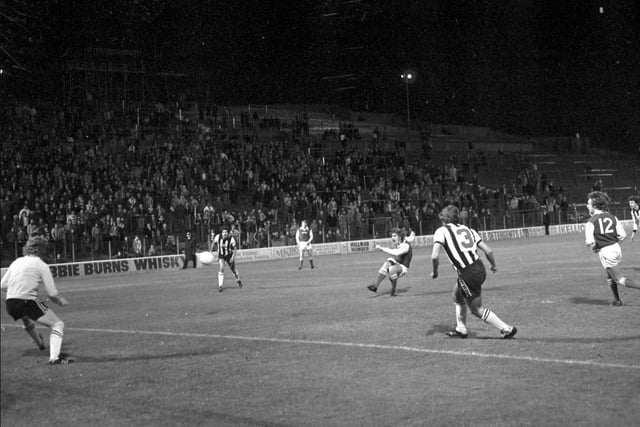 Tony Higgins has a shot on goal during a match between Hibs and Newcastle in September 1977
