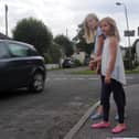 Charlotte and Emily watch a car speed by.  Picture credit Rob Lacey.