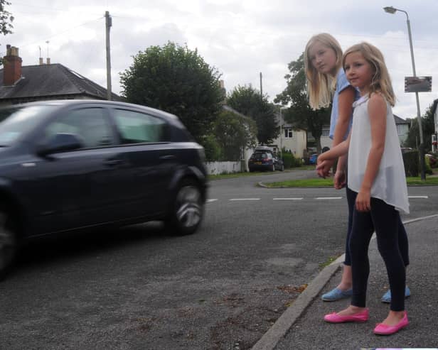 Charlotte and Emily watch a car speed by.  Picture credit Rob Lacey.