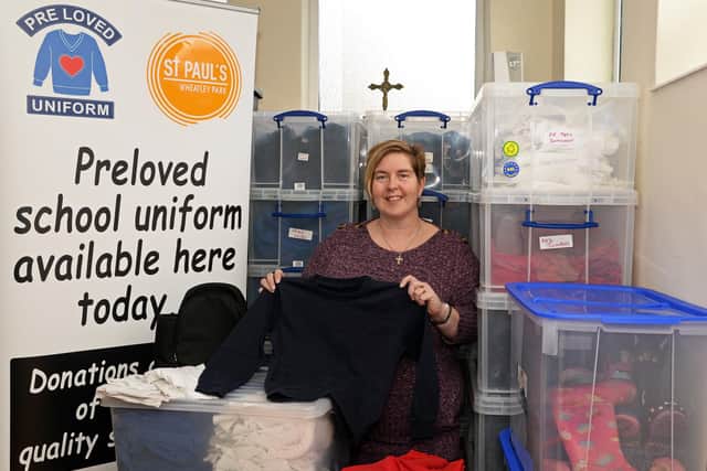 Tracey Leigh, pictured at St. Paul's Community Church, with some of the uniforms that have been collected.