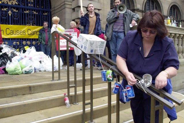 A protestor trims the Town Hall steps with rubbish to make the council aware of their feelings against the Brenard Road Incinerator